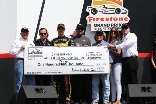 Sebastien Bourdais on stage to donate to the Johns Hopkins All Children's Hospital during pre-race festivities for the Firestone Grand Prix of St. Petersburg -- Photo by: Chris Jones
