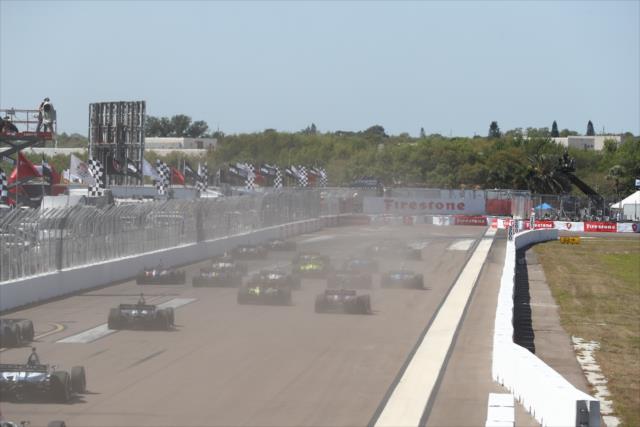 The field streams down to Turn 1 at the start of the Firestone Grand Prix of St. Petersburg -- Photo by: Chris Jones