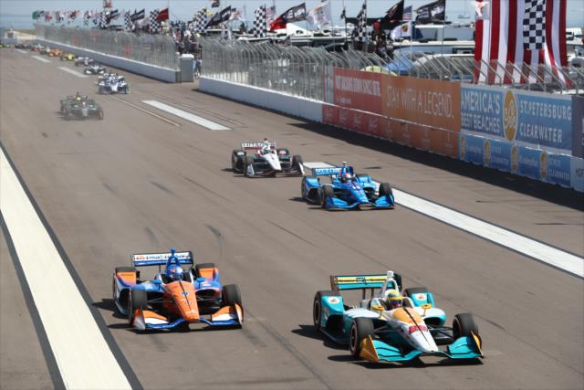 Gabby Chaves and Scott Dixon lead a parade of cars down the frontstretch during the start of the Firestone Grand Prix of St. Petersburg -- Photo by: Chris Jones