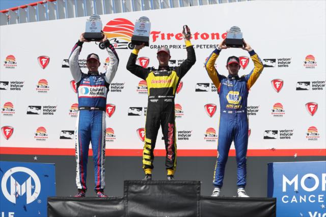 The podium of Sebastien Bourdais, Graham Rahal, and Alexander Rossi with their trophies in Victory Circle following the Firestone Grand Prix of St. Petersburg -- Photo by: Chris Jones