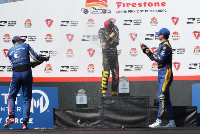 The champagne flies in Victory Circle for Sebastien Bourdais, Graham Rahal, and Alexander Rossi following the Firestone Grand Prix of St. Petersburg -- Photo by: Chris Jones