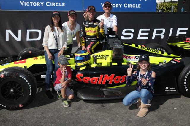 Sebastien Bourdais with his family in Victory Circle after winning the Firestone Grand Prix of St. Petersburg -- Photo by: Chris Jones