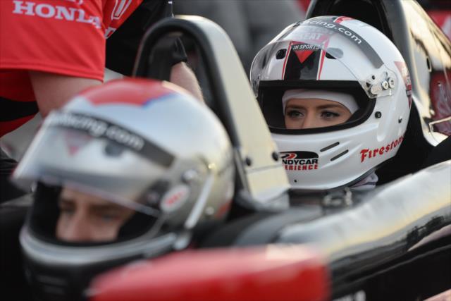 Lauren Burnham sits behind her fiancee Arie Luyendyk Jr. before their two-seater drive around the Streets of St. Petersburg -- Photo by: James  Black