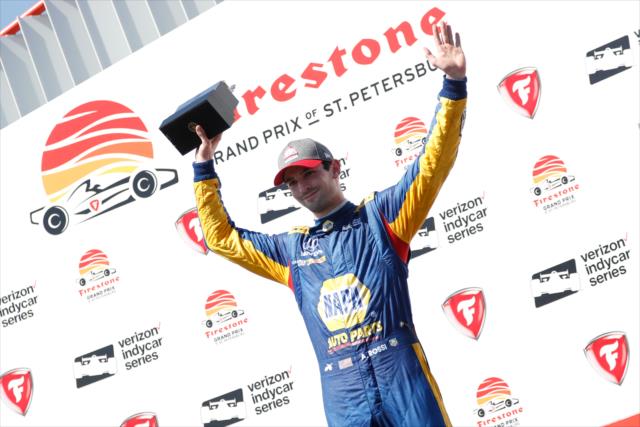 Alexander Rossi accepts his 3rd Place trophy in Victory Circle following the Firestone Grand Prix of St. Petersburg -- Photo by: Joe Skibinski
