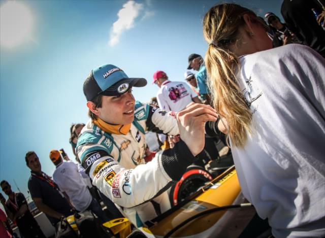 Gabby Chaves signs an autograph on the grid prior to the start of the Firestone Grand Prix of St. Petersburg -- Photo by: Shawn Gritzmacher