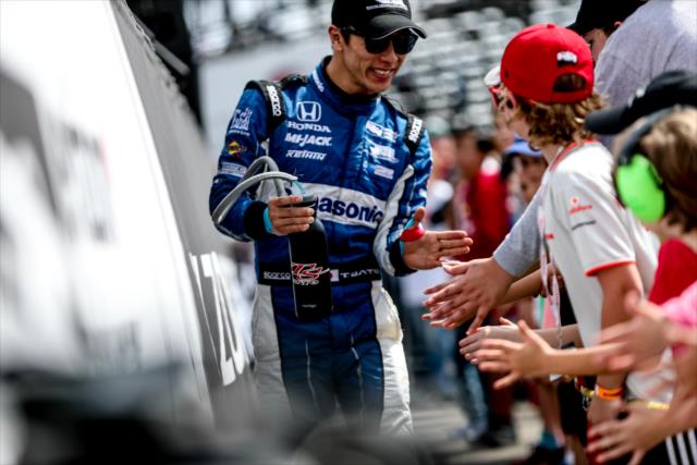 Takuma Sato gives young fans high-fives during pre-race introductions for Firestone Grand Prix of St. Petersburg -- Photo by: Shawn Gritzmacher