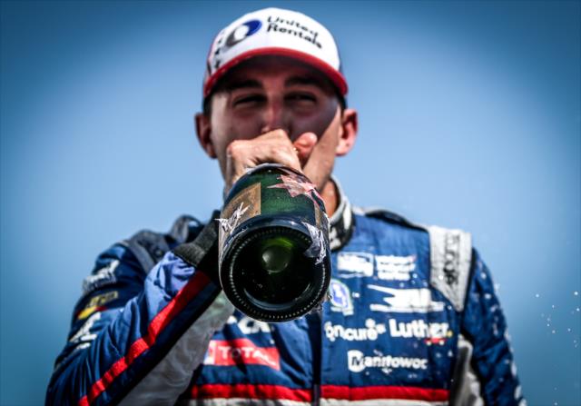 Graham Rahal with a cold sip of champagne following his 2nd Place finish in the Firestone Grand Prix of St. Petersburg -- Photo by: Shawn Gritzmacher