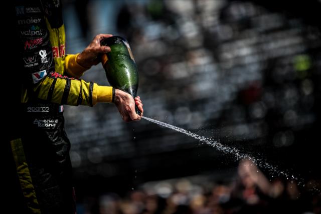 Sebastien Bourdais sprays the champagne in Victory Circle following his win in the Firestone Grand Prix of St. Petersburg -- Photo by: Shawn Gritzmacher