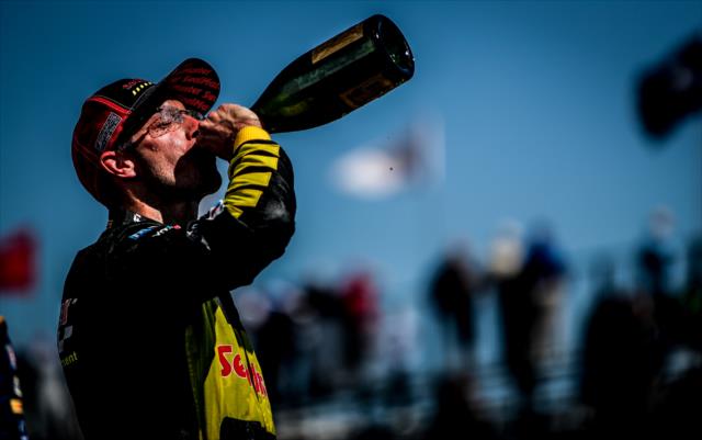 Sebastien Bourdais sips the champagne in Victory Circle following his win in the Firestone Grand Prix of St. Petersburg -- Photo by: Shawn Gritzmacher