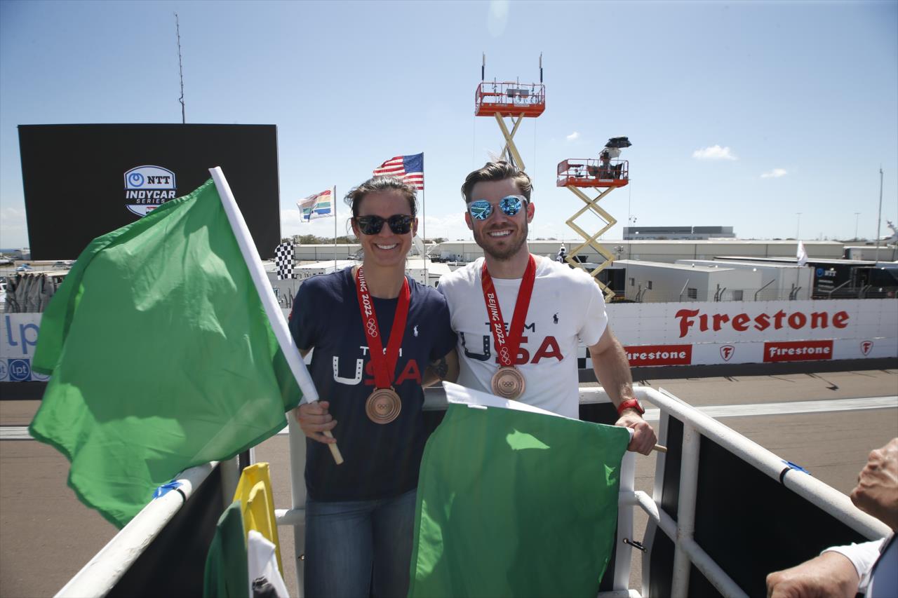 Bronze medalists Brittany Bowe and Joey Mantia wave the green flag to start the race - Firestone Grand Prix of St. Petersburg - By: Chris Jones -- Photo by: Chris Jones