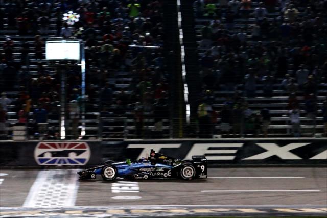 Scott Dixon takes the twin checkers to win the Firestone 600 at Texas Motor Speedway -- Photo by: Chris Jones