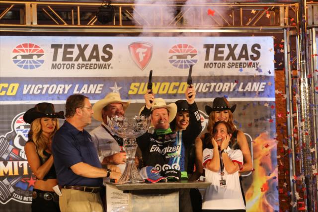 Scott Dixon fires off the six-shooters in Victory Lane following his win in the Firestone 600 at Texas Motor Speedway -- Photo by: Chris Jones