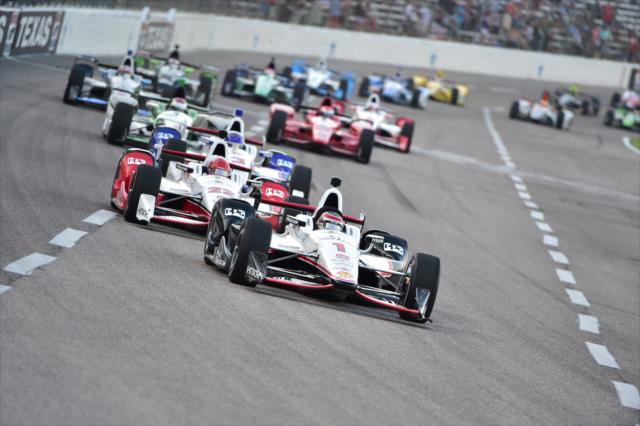 Will Power and Simon Pagenaud lead the field into Turn 1 during the early stages of the Firestone 600 at Texas Motor Speedway -- Photo by: Chris Owens