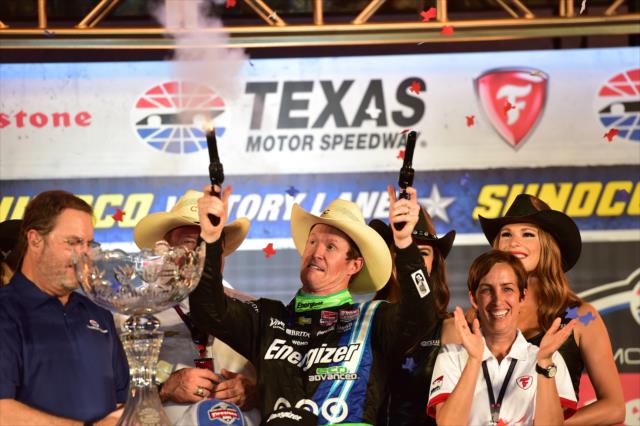Scott Dixon fires off the six-shooters in Victory Lane following his win in the Firestone 600 at Texas Motor Speedway -- Photo by: Chris Owens