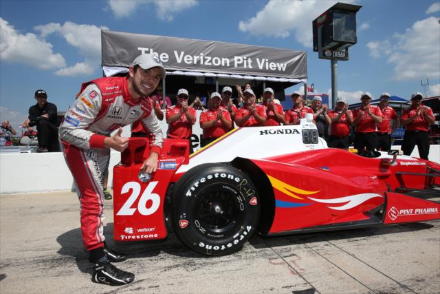 Carlos Munoz affixes the Verizon P1 Award emblem for winning the pole position for the Firestone 600 at Texas Motor Speedway -- Photo by: Chris Jones