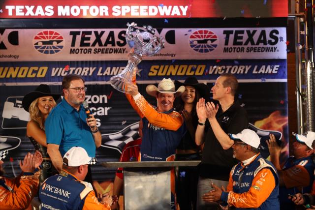 Scott Dixon hoists the Foyt-Rutherford Trophy in Victory Lane after winning the DXC Technology 600 at Texas Motor Speedway -- Photo by: Chris Jones