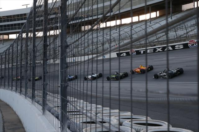 The field streams through Turn 4 to start the DXC Technology 600 at Texas Motor Speedway -- Photo by: Chris Jones