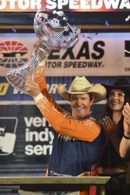 Scott Dixon hoists the Foyt-Rutherford trophy in Victory Lane after winning the DXC Technology 600 at Texas Motor Speedway -- Photo by: Chris Owens