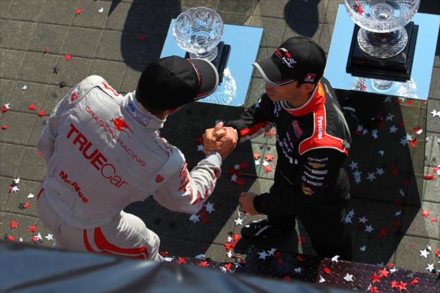 Sebastien Bourdais and Helio Castroneves congratulate each other on their podiums -- Photo by: Chris Jones