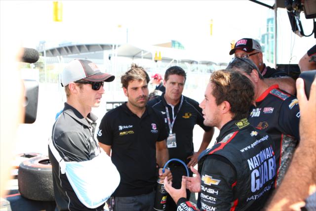 Carlos Munoz talks with Ryan Briscoe and Panther Racing prior to practice -- Photo by: Chris Jones
