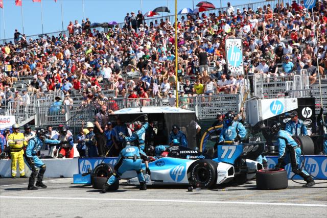Simon Pagenaud and the Schmidt Hamilton Motorsports team perform an early pit stop -- Photo by: Chris Jones