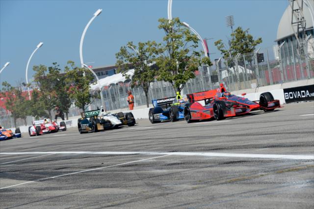 Sebastien Bourdais leads a gaggle of cars into pit lane -- Photo by: Chris Owens