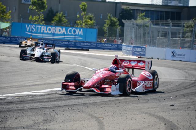 Scott Dixon in the apex of Turn 10 as Will Power begins his entrance to pit lane -- Photo by: Chris Owens