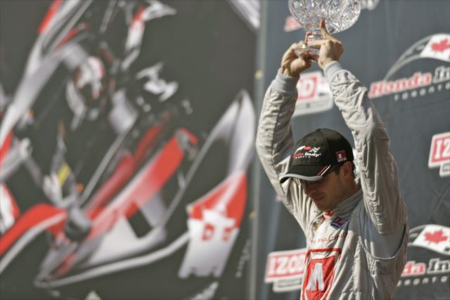 Sebastien Bourdais raises his trophy high after his 3rd place finish -- Photo by: Shawn Gritzmacher