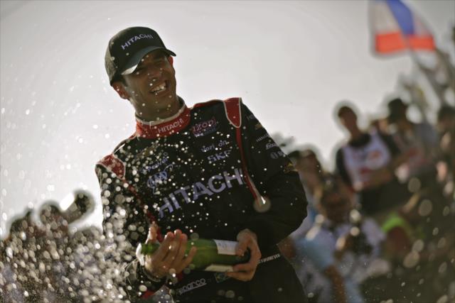 Helio Castroneves sprays the champagne in Toronto -- Photo by: Shawn Gritzmacher