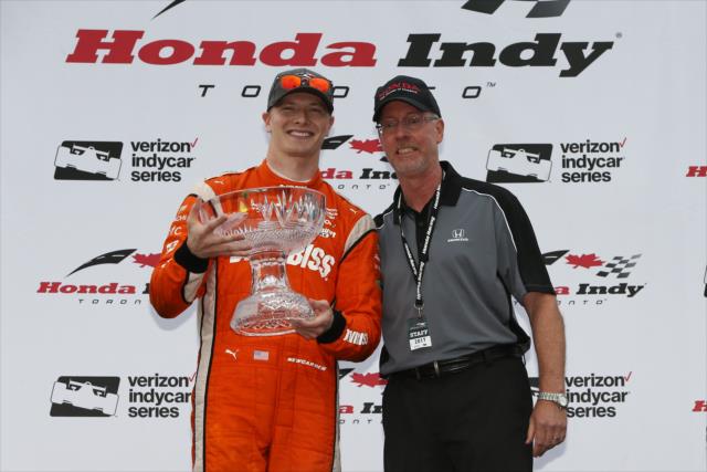 Josef Newgarden accepts his 1st Place trophy in Victory Circle after winning the 2017 Honda Indy Toronto -- Photo by: Chris Jones