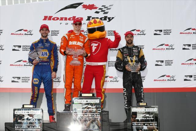 The podium of Josef Newgarden, Alexander Rossi, and James Hinchcliffe with their trophies and the Firestone Firehawk following the Honda Indy Toronto -- Photo by: Chris Jones