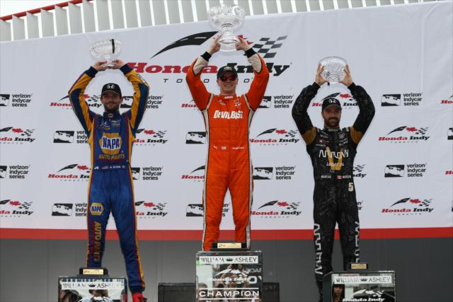 Josef Newgarden, Alexander Rossi, and James Hinchcliffe hoist their trophies in Victory Circle following the Honda Indy Toronto -- Photo by: Chris Jones