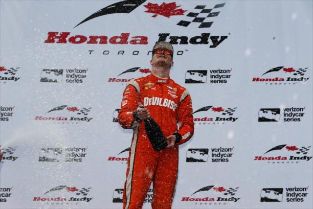 Josef Newgarden sprays the champagne in Victory Circle after winning the 2017 Honda Indy Toronto -- Photo by: Chris Jones