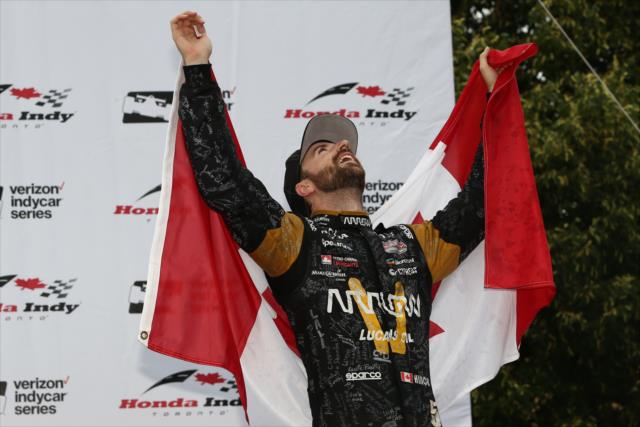 James Hinchcliffe celebrates in Victory Circle with the Canadian flag after his 3rd Place finish in the Honda Indy Toronto -- Photo by: Chris Jones