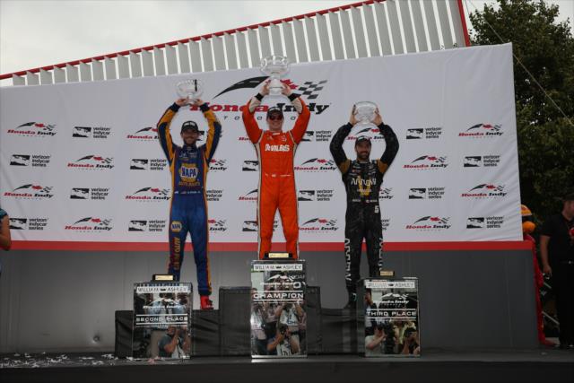 Josef Newgarden, Alexander Rossi, and James Hinchcliffe hoist their trophies in Victory Circle following the Honda Indy Toronto -- Photo by: Chris Jones