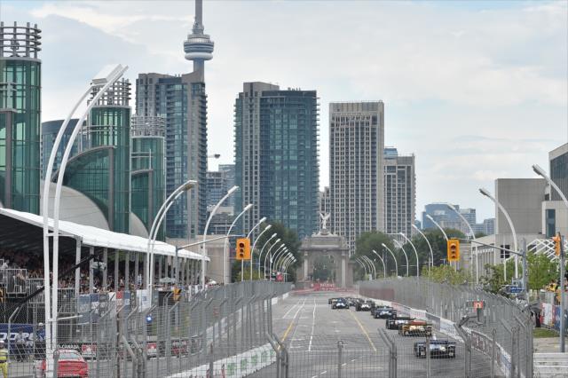 The field streams down the frontstretch during the Honda Indy Toronto -- Photo by: Chris Owens