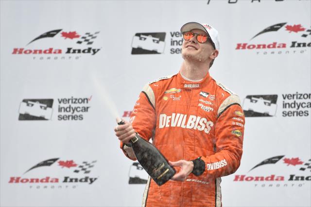 Josef Newgarden sprays the champagne in Victory Circle after winning the 2017 Honda Indy Toronto -- Photo by: Chris Owens