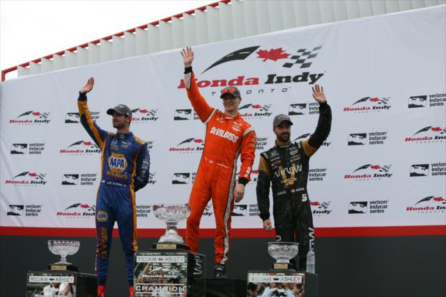 Josef Newgarden, Alexander Rossi, and James Hinchcliffe waive to the fans in Victory Circle following the Honda Indy Toronto -- Photo by: Joe Skibinski
