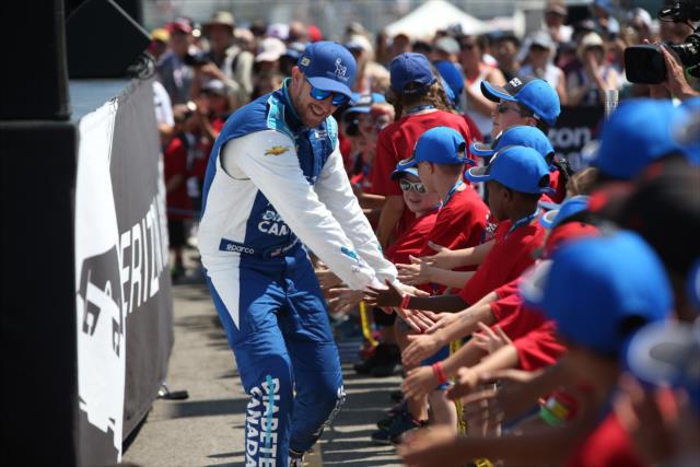 Charlie Kimball greets the young fans in front of the stage during pre-race introductions for the Honda Indy Toronto -- Photo by: Chris Jones