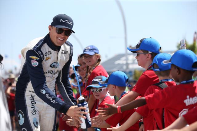 Max Chilton greets the young fans in front of the stage during pre-race introductions for the Honda Indy Toronto -- Photo by: Chris Jones