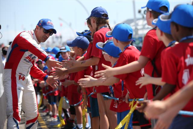 Tony Kanaan greets the young fans in front of the stage during pre-race introductions for the Honda Indy Toronto -- Photo by: Chris Jones