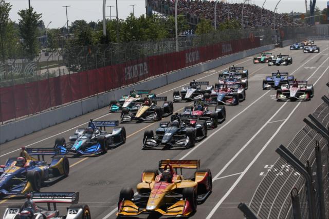 The field streams down the frontstretch to the green flag to start the Honda Indy Toronto -- Photo by: Chris Jones