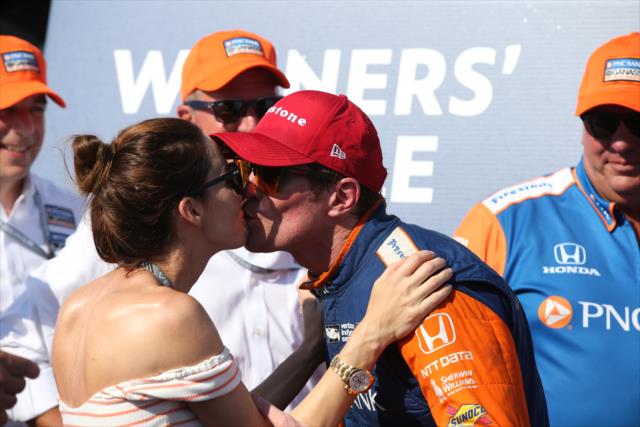 Scott Dixon gets a kiss from his wife, Emma, in Victory Circle after winning the Honda Indy Toronto -- Photo by: Chris Jones