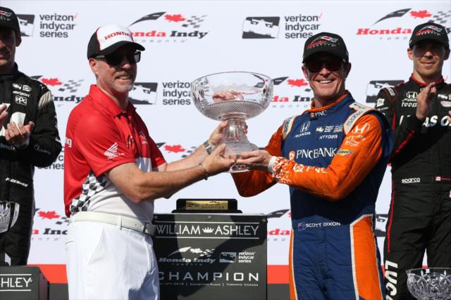 Scott Dixon is presented his 1st Place trophy in Victory Circle following his win in the Honda Indy Toronto -- Photo by: Chris Jones