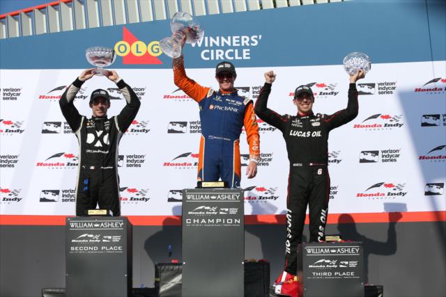 Scott Dixon, Simon Pagenaud, and Robert Wickens hoist their trophies in Victory Circle following the Honda Indy Toronto -- Photo by: Chris Jones