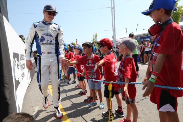 Spencer Pigot greets some young fans in front of the stage during pre-race introductions for the Honda Indy Toronto -- Photo by: Chris Jones