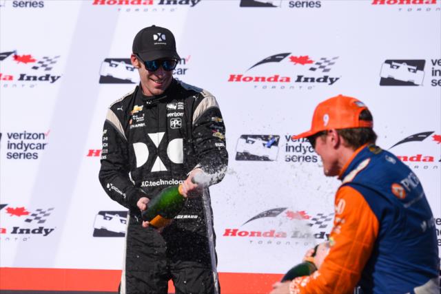 Simon Pagenaud and Scott Dixon spray the champagne in Victory Circle following the Honda Indy Toronto -- Photo by: James  Black