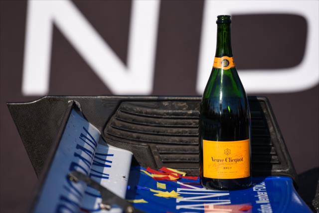 An empty bottle of champagne sits on the winning No. 9 PNC Bank Honda of Scott Dixon in Victory Circle following the Honda Indy Toronto -- Photo by: James  Black