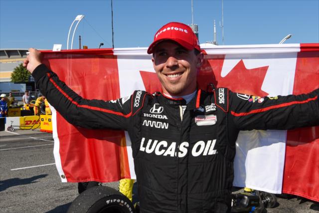 Robert Wickens celebrates with the Canadian Flag in Victory Circle after his 3rd Place finish in the Honda Indy Toronto -- Photo by: James  Black