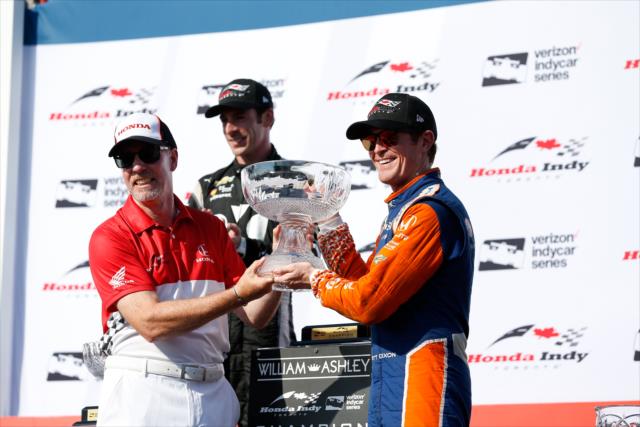 Scott Dixon accepts his 1st Place trophy in Victory Circle after winning the Honda Indy Toronto -- Photo by: Joe Skibinski